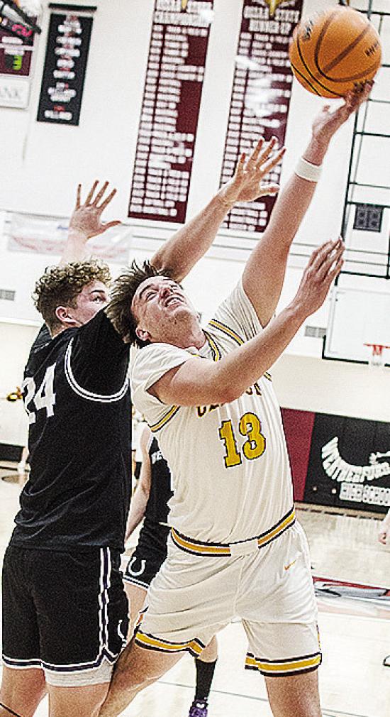 No. 13 Ethan Lofland gets around the defender for the layup during Clinton’s playoff game against Bethany Friday night in Weatherford. CDN | Sam Goodwyn