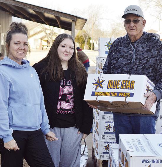 From left, Clinton Mission House Director Jennifer Lee, Abbey Shields, and Board Member Sam Shelton unload a pallet of pears delivered Thursday morning to the Mission House. CDN | Micah Ashcraft