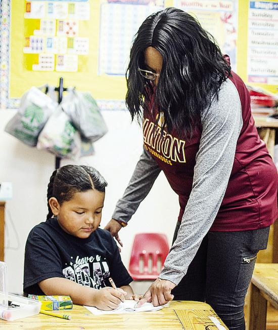 Khalil Douglas, left, gets help from Tosha Jones on a coloring book of Martin Luther King Jr. to celebrate Black History Month at Eastside Academy. CDN | Sam Goodwyn Khalil Douglas, left, gets help from Tosha Jones on a coloring book of Martin Luther King Jr. to celebrate Black History Month at Eastside Academy. CDN | Sam Goodwyn