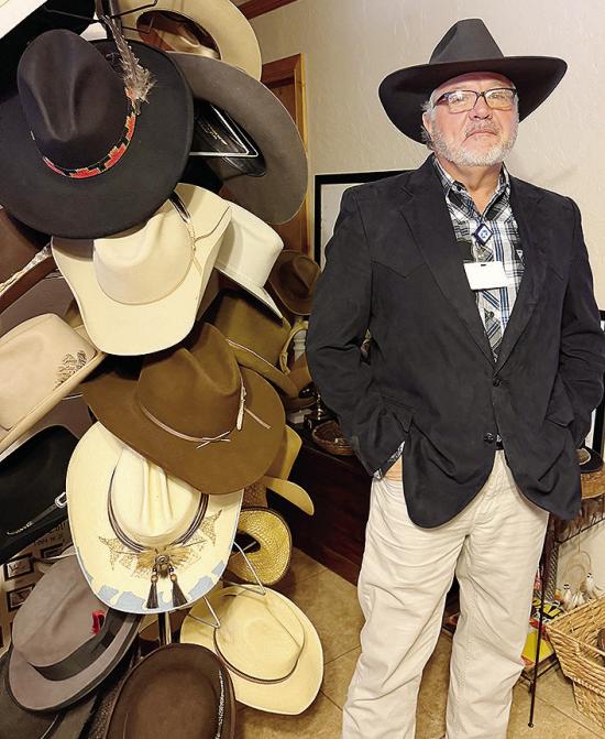 Wearing his favorite hat, Gary Albert stands next to a small portion of his collection. CDN | Shiann Dawson