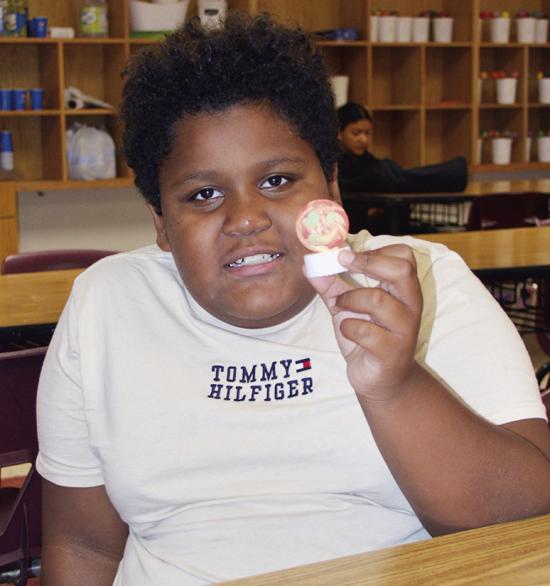 Ian Aguilar shows off his ping pong light made during the Discovery Zone class taught by JoDee Adney Wednesday at Washington Elementary. CDN | Christian Jacobsen