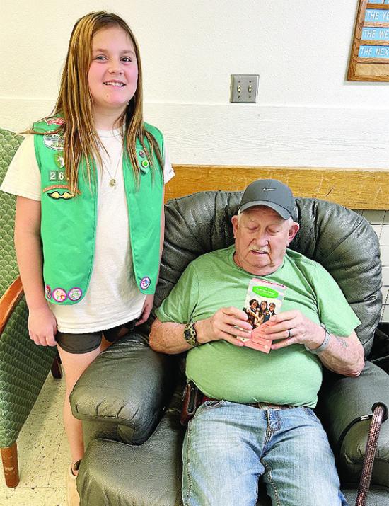 Girl Scout Preslie Hines, left, presents Thomas Newman with a free box of cookies at the Veterans Center. Troop No. 262 took 110 boxes of cookies out to the facility. CDN | Courtesy photo