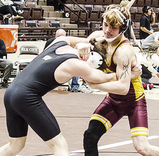 Clinton’s Landon Wilson, right, grapples with his opponent during the Class 4A District Duals Tuesday in Elk City. CDN | Sam Goodwyn