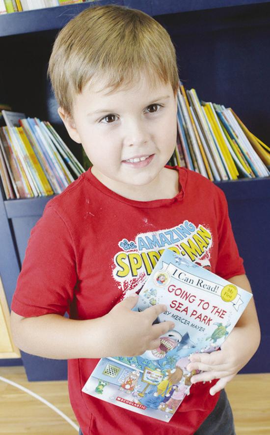 Judah Wagnon decides to select “Going to the Sea Park” as his free book from the Rolling Thunder Book Bus at the Frisco Center. CDN | Christian Jacobsen Judah Wagnon decides to select “Going to the Sea Park” as his free book from the Rolling Thunder Book Bus at the Frisco Center. CDN | Christian Jacobsen