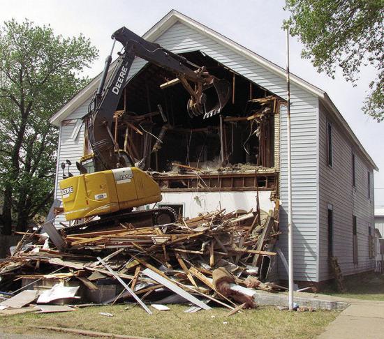 The Mission House living quarters gets torn into by an excavator around noon Tuesday. The Mission House’s kitchen will be closed until further notice during the demolition process. CDN | Christian Jacobsen