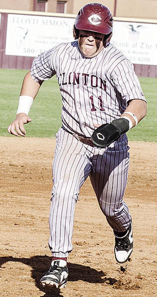 Clinton’s Eli Anderson hustles to third base during the Reds’ home game against El Reno. CDN | Sam Goodwyn