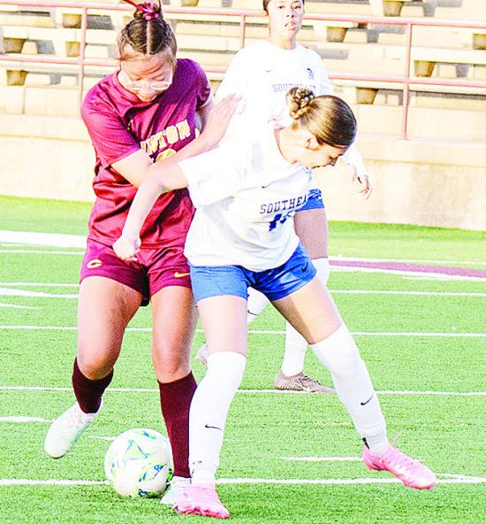 Clinton’s Leila Pete, left, fights through a Southeast defender during the Lady Reds’ home win over the Lady Spartans. CDN | Sam Goodwyn