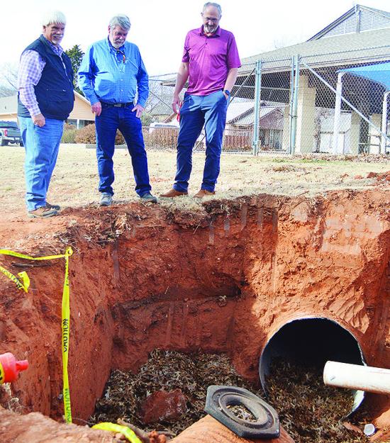 From left, Dist. 1 Commissioner Wade Anders, Gary Brickley, and Clinton Public Works Director Gene McCullough take note of the state of a damaged drainage pipe Monday afternoon in McLain Rogers Park, just outside of the Clinton Public Pool. CDN | Micah As From left, Dist. 1 Commissioner Wade Anders, Gary Brickley, and Clinton Public Works Director Gene McCullough take note of the state of a damaged drainage pipe Monday afternoon in McLain Rogers Park, just outside of the Clinton Public Pool. CDN | Micah As