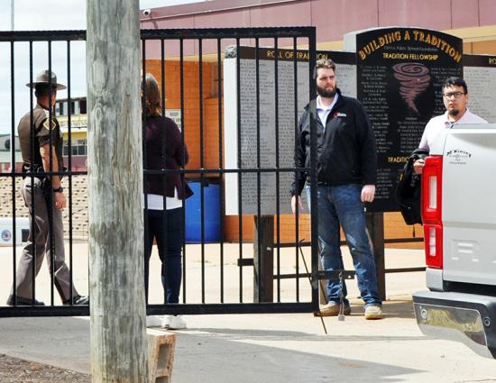 From left, Oklahoma Highway Patrol Lt. Aaron Hunter, Clinton Public Schools Assist. Supt. Melissa Knabe, Clinton Police Department Detective Paul Sperle and Detective Calvin Ramirez secure the north entrance to the Tornado Bowl Friday. CDN | Staff Photo