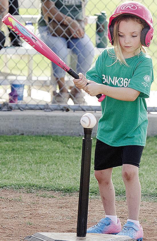Kezli Cox focuses on the ball as she goes into her swing during her Noon Lion’s Club T-Ball game at Schumacher Fields at Acme Brick Park CDN |Sam Goodwyn Kezli Cox focuses on the ball as she goes into her swing during her Noon Lion’s Club T-Ball game at Schumacher Fields at Acme Brick Park CDN |Sam Goodwyn