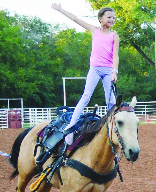 Josie Nichepor with her horse, Lizzy, practice trick riding moves Wednesday afternoon at the Clinton Rodeo Grounds. The Clinton Rodeo will take place tonight and tomorrow, with a scheduled parade at 10 a.m. tomorrow morning down Frisco Avenue. CDN | Chris Josie Nichepor with her horse, Lizzy, practice trick riding moves Wednesday afternoon at the Clinton Rodeo Grounds. The Clinton Rodeo will take place tonight and tomorrow, with a scheduled parade at 10 a.m. tomorrow morning down Frisco Avenue. CDN | Chris
