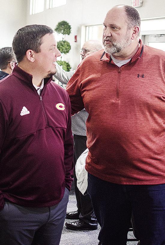 Clinton’s new football coach Trevor Powers, left, talks with Jeff Johnson during the Chamber of Commerce Luncheon Monday at the Frisco Center. CDN | Sam Goodwyn
