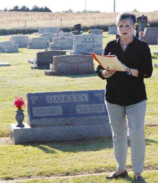 Sharon Meacham stands near the Dorsey family plot as she tells the story of her uncles and their running of the Route 66 Fruit Market Monday evening during the 2026 Spring Cemetery Walk at the Clinton Cemetery. CDN | Christian Jacobsen