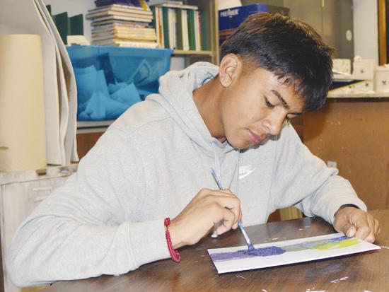 Fabian Martinez adds additional colors to his abstract art piece at Clinton High School. CDN | Christian Jacobsen Fabian Martinez adds additional colors to his abstract art piece at Clinton High School. CDN | Christian Jacobsen
