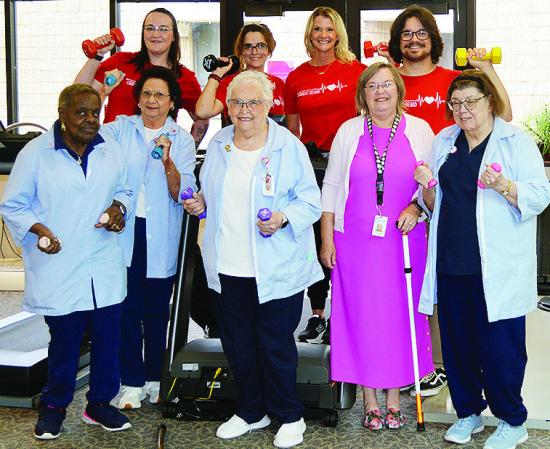 Celebrating the recent donation of a treadmill and dumbbells to the Cardiac Rehab department are front, from left, volunteers, Gloria Brown, Norma Fisher, Lois Schimmels, Debra Mendez, and Glenda Kindsfather; back, staff, Khristen Sawatzky, Janie Arnett, 