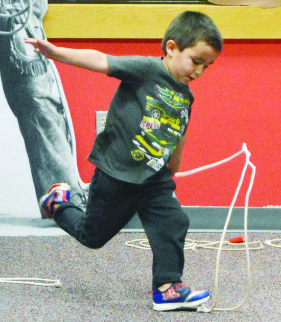 Sully Acosta winds up a spin to get his lasso to move faster than he previously did, at the Clinton Public Library.