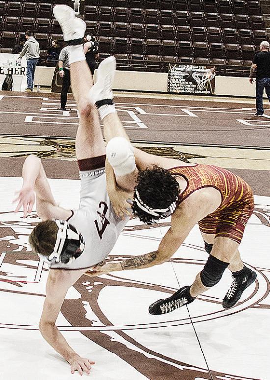 Clinton’s Tristan Cardenas, right, throws his opponent to the mat during the District Duals in Elk City. CDN | Sam Goodwyn