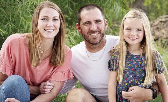 New Clinton Defensive Coordinator Skylar Watson, center, smiles with his wife Jannie, left, and daughter Journey, right. CDN | Courtesy photo