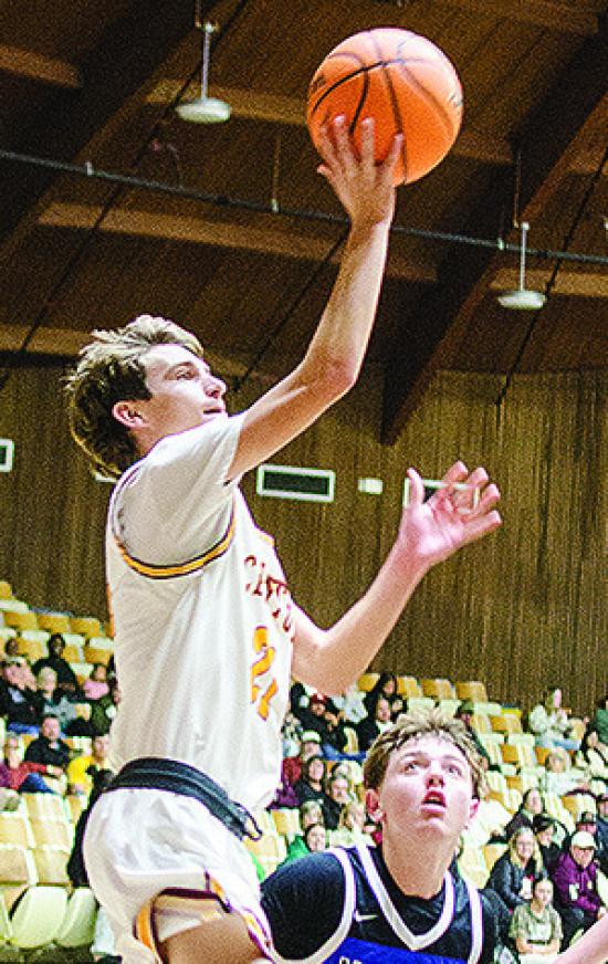 No. 21 Snider Dowdell shoots the ball after fighting to get past a Harrah defender during Clinton’s season-opening win over the Panthers Tuesday in the Tornado Dome. CDN | Sam Goodwyn