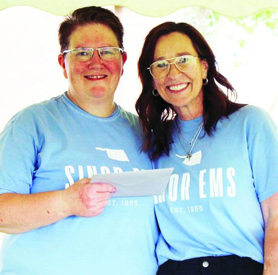EMS Director Michelle Addington, left, is recognized for her 25 years of service by Sinor CEO Anne Lambeth.