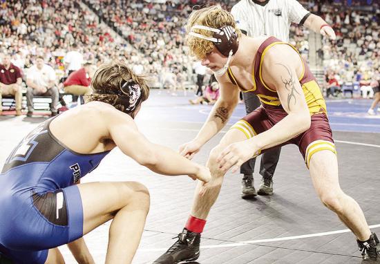 Clinton’s Landon Wilson, right, eyes an opening against his opponent from Harrah in Class 4A 165-pound weight class championship match Saturday at OG&amp;E Coliseum in Oklahoma City. CDN | Sam Goodwyn