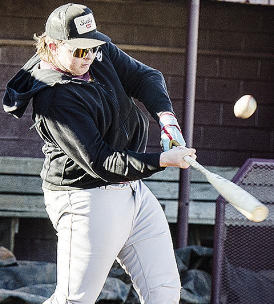 Clinton’s Dylan Hoffman hits the ball hard during practice at the baseball field. CDN | Sam Goodwyn
