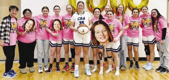 The Corn Bible Academy Lady Crusaders celebrate as Kate Stewart, center, scored her 1,000th career point for CBA on a threepoint shot during the Lady Crusaders’ 60-56 overtime loss last Friday to Pioneer-Pleasant Vale during the Burlington Tournament. P