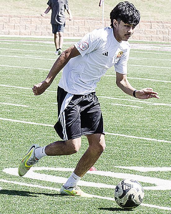 Recent Clinton graduate Antonio Soto runs with the ball during a practice this spring in the Tornado Bowl. CDN | Sam Goodwyn