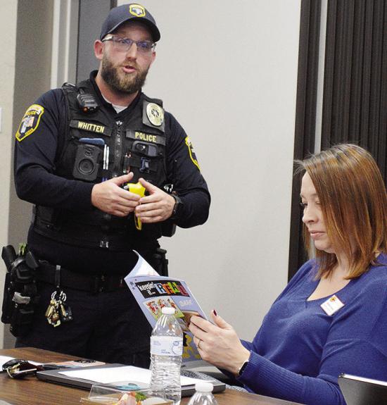 Clinton Police Student Resource Officer Dillon Whitten, left, speaks to the Clinton Public Schools Board of Education about the modern D.A.R.E. program, while Asst. Supt. Melissa Knabe reads the provided material. CDN | Micah Ashcraft