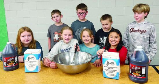 Arapaho-Butler Elementary School students prepare for the upcoming pancake dinner. Front row from left are Briella Ray, Kasydi Guthrie, Mackee Chisum, and Vivienne Rosales; back, Rowdy Bond, Jagger Hulett, Blain Palmer, and Clint Roush. CDN | Shiann Dawso