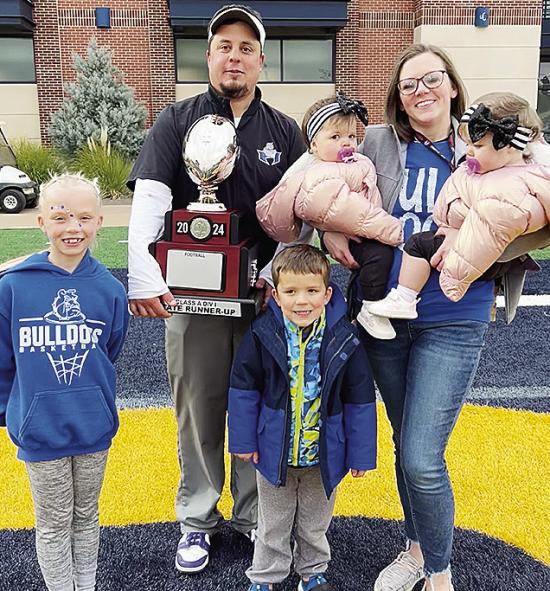 Soon to be newly-appointed Clinton football coach Trevor Powers, center, smiles with his family after finishing as runner-up in the Class A State Championship game at UCO. Pictured, from left, are daughter Tenley, Powers, son Jet, wife Shayla and twin dau