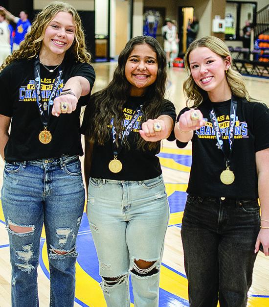 During halftime of Tuesday’s Arapaho-Butler boys’ basketball game, the Lady Indians fast-pitch softball State Championship team received their rings. From left, Dalaynie Lee, Adrian Randle, and Reagan Schoeppach, show off their rings. CDN | Sam Goodwy