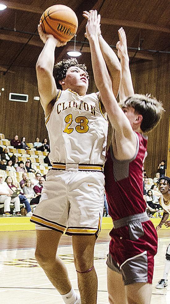 No. 23 Easten Powell jumps for the contested layup during Clinton’s regular season finale against Weatherford. CDN | Sam Goodwyn