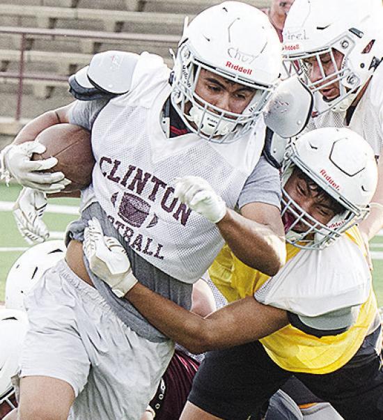Clinton’s Jesus Gutierrez, left, runs through CJ Begay’s tackle during Monday’s football practice at the Tornado Bowl. CDN | Sam Goodwyn