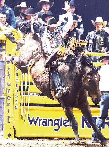 Arapaho’s Wacey Schalla holds on tight to a bronco during a recent rodeo event. CDN | Courtesy photo