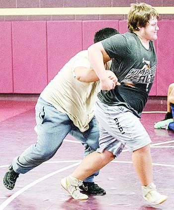 Clinton’s Isaiah Dustman, right, breaks free of Sammy Zheng’s grasp during an open gym practice over winter break in the wrestling room. CDN | Sam Goodwyn