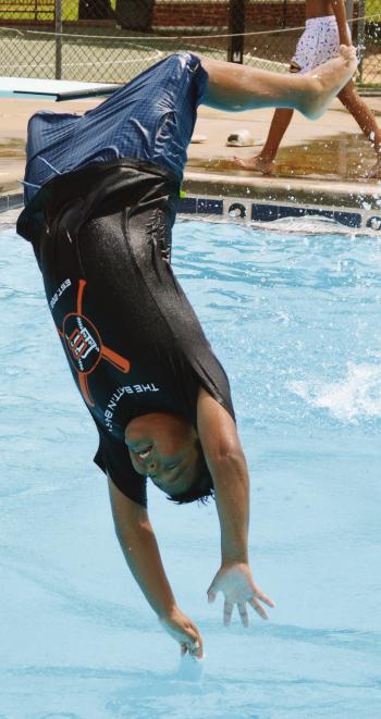 Cruz Standingwater gets too much bounce and his legs fly away at the Clinton Public Pool. CDN | Christian Jacobsen