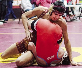 Clinton’s Vicente Gutierrez, top, tries to roll his opponent over during the annual Hub City Tournament Friday in the Tornado Dome. CDN | Sam Goodwyn