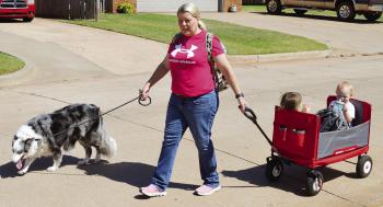 Stephanie Raab, with her dog Mayday, picks up her grandchildren Carmin and Bexleigh Raab from daycare on 25th Street. CDN | Christian Jacobsen
