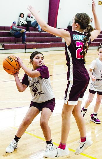 Maddi Esquivel, left, avoids the Sayre defender during Clinton’s fourth-grade girls’ basketball game at the practice gym. CDN |Sam Goodwyn