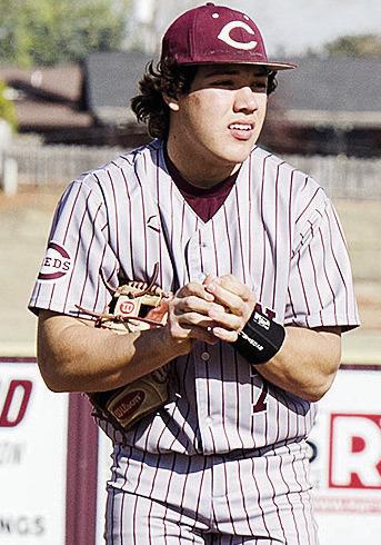 Clinton’s Easten Powell rubs the ball as he prepares to pitch during the Reds’ spring home game against El Reno. CDN | Sam Goodwyn