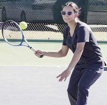 Clinton’s Idalia Pelayo focuses on the ball as she prepares to hit it turning tennis practice on the courts at the high school. CDN | Sam Goodwyn