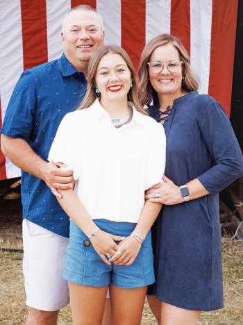 New Clinton offensive coordinator Garrett Harland, left, smiles with his daughter Aubren, center and wife Kambri. CDN | Courtesy photo