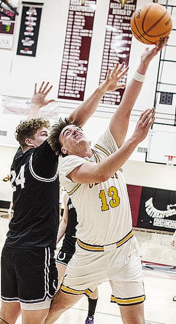 No. 13 Ethan Lofland gets around the defender for the layup during Clinton’s playoff game against Bethany Friday night in Weatherford. CDN | Sam Goodwyn