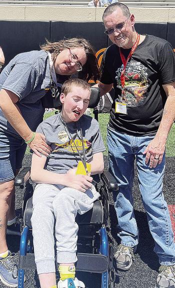 Andrew Schantz, center, enjoys the day at Oklahoma State with his mom, Julia, left, and dad Bobby, right, during the Special Olympics Summer State Games. CDN |Courtesy Photo