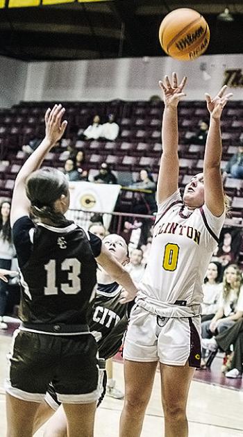Clinton’s Laney Anderson, right, shoots over the Elk City defender Saturday during the Lady Reds’ home game. CDN | Sam Goodwyn