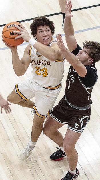 Clinton’s Easten Powell fights through the Elk City defender Thursday during the Reds’ win over the Elks in the Class 4A playoff game in Weatherford. CDN | Sam Goodwyn