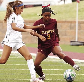 Clinton’s Peyton Clonce, right, tries to avoid the Elk City defender during the Lady Reds’ home game against the Elkettes in the spring. CDN | Steve Wheeler