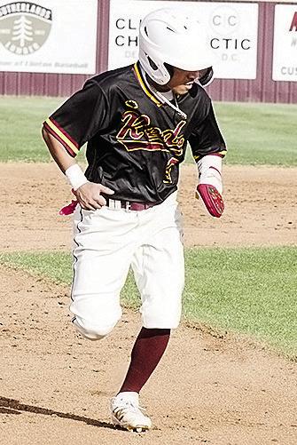 Clinton’s Azreal Fierros hustles to third during the Reds’ home game Monday against Woodward. CDN | Sam Goodwyn