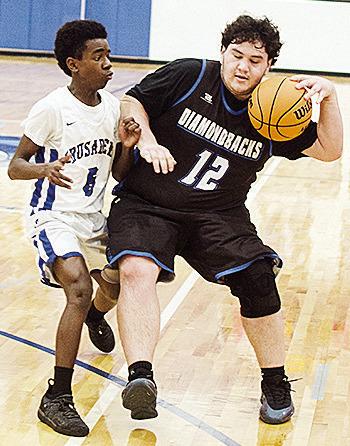 CBA’s Rolando Beadle guards the Olustee-Eldorado player as he tries to dribble the ball up the court in the Crusaders’ home win Thursday over the Diamondbacks. CDN | Sam Goodwyn